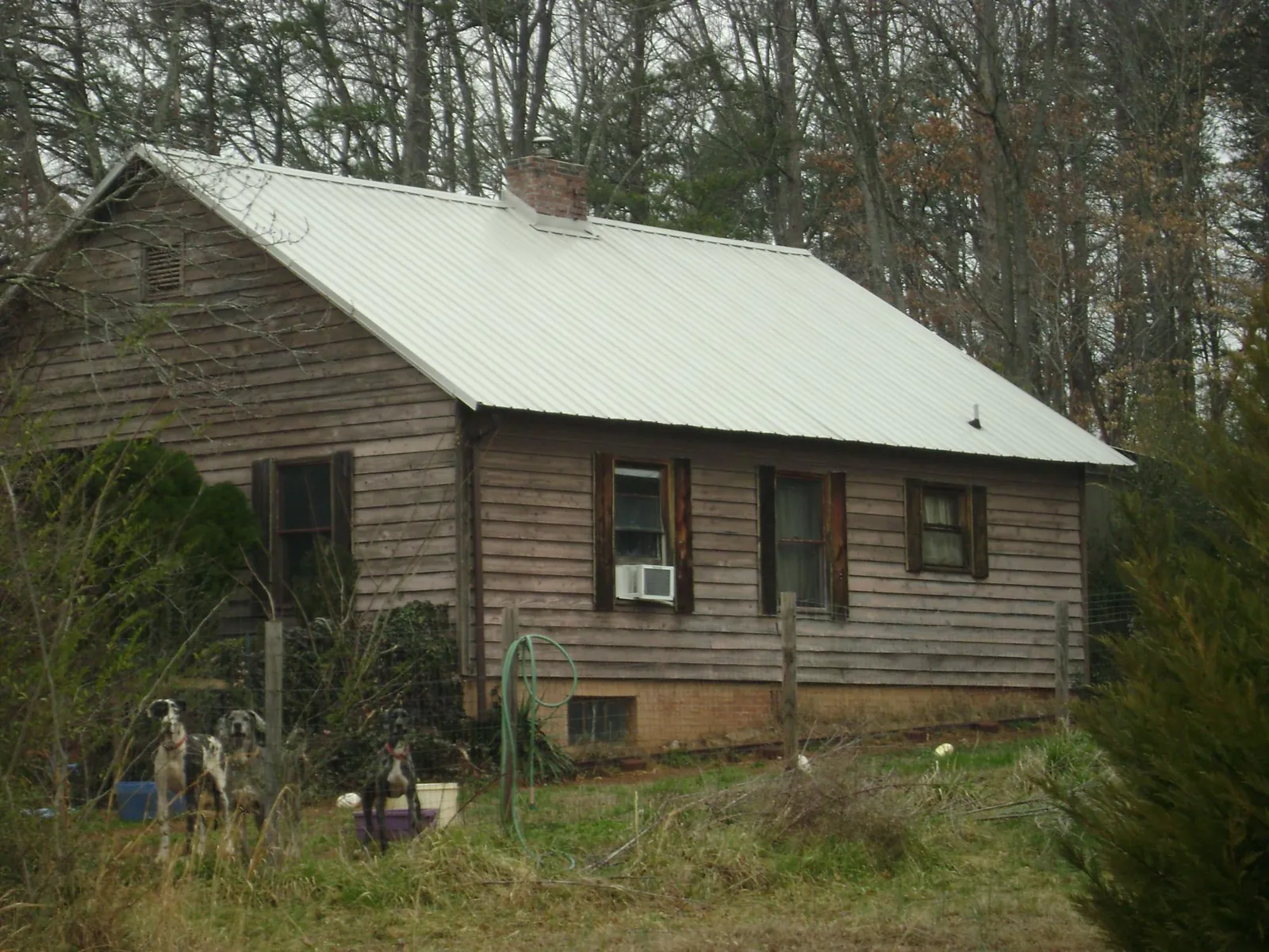 White metal roof on an old wood sided farmhouse, from a Metal Roof Installation job in Boalsburg