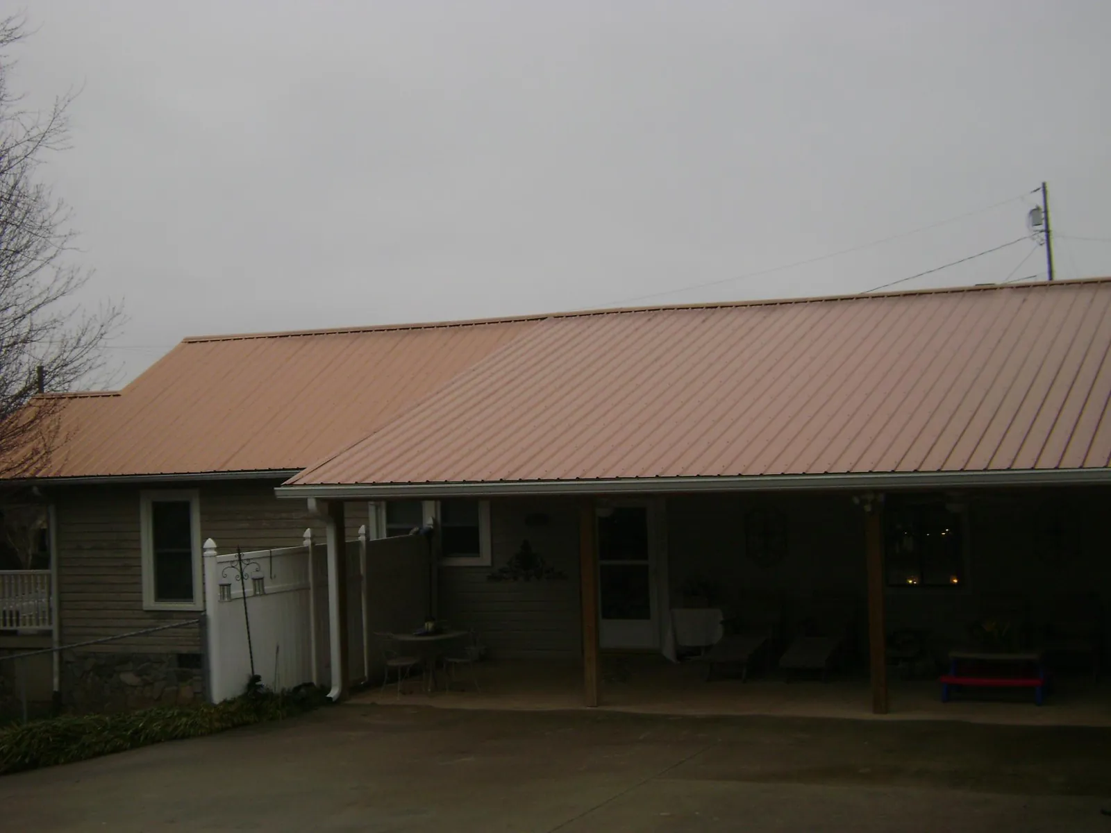 Copper toned metal roof over a wide covered patio in Boalsburg